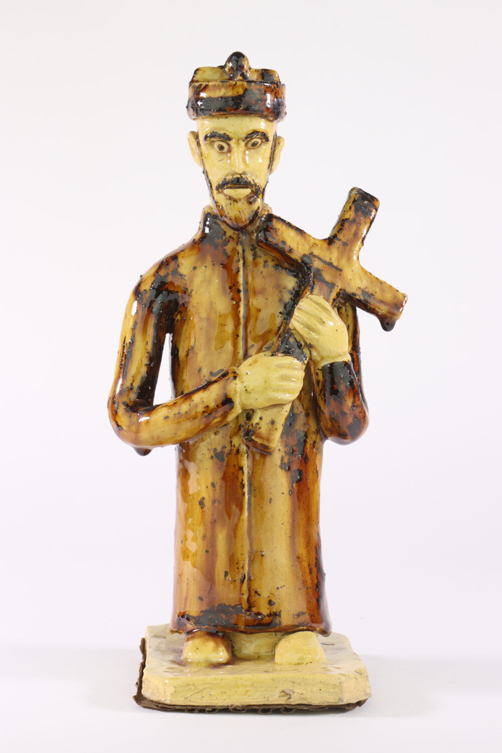 Mężczyzna trzymający w ręce krzyż - rzeźba