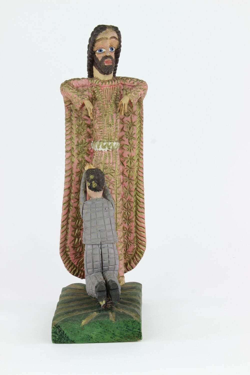 Chłopiec klęczy przed mężczyzną - rzeźba